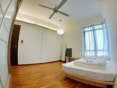 a bedroom with a bed and a ceiling fan at Spacious 4BR condo near KLCC - Travel with MRT in Kuala Lumpur