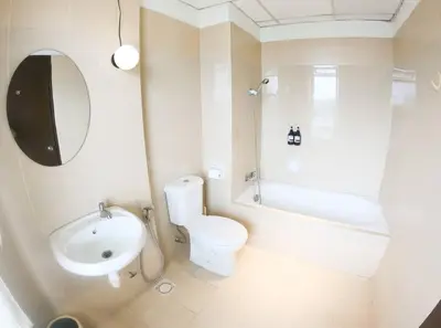 a white bathroom with a toilet and a sink at Spacious 4BR condo near KLCC - Travel with MRT in Kuala Lumpur