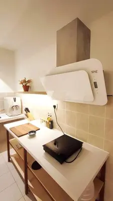 a kitchen with a microscope on a white counter at Spacious 4BR condo near KLCC - Travel with MRT in Kuala Lumpur