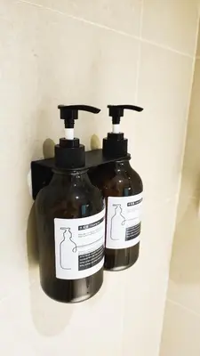 two bottles of soap sitting on a wall at Spacious 4BR condo near KLCC - Travel with MRT in Kuala Lumpur