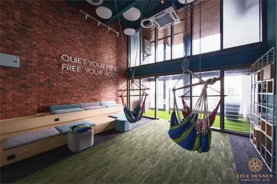 a room with two hammocks hanging from a brick wall at Riveria Premium Kuala Lumpur, Roam in Kuala Lumpur