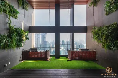 a room with two chairs and a large window at Riveria Premium Kuala Lumpur, Roam in Kuala Lumpur
