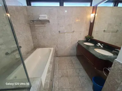 a bathroom with two sinks and a bath tub at Premier CityView Times Square Apartment KL in Kuala Lumpur