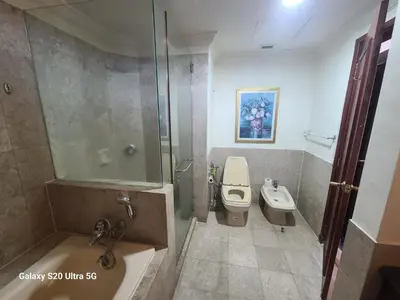 a bathroom with a shower and a toilet and a sink at Premier CityView Times Square Apartment KL in Kuala Lumpur