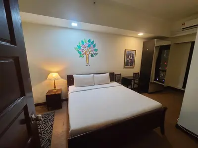 a bedroom with a bed in a room with a lamp at Premier CityView Times Square Apartment KL in Kuala Lumpur