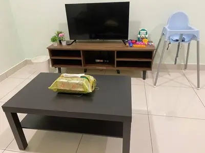 a living room with a table with a tv and a table at Ampang 4-5 pax in Ampang Point in Ampang