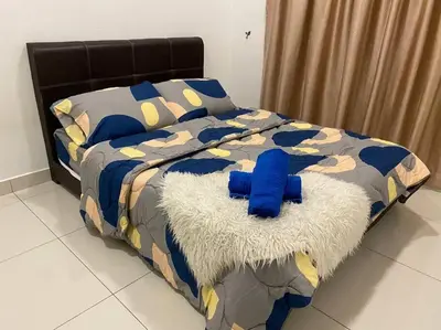 a bed with a blue stuffed animal on top of it at Ampang 4-5 pax in Ampang Point in Ampang