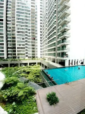 a large building with a swimming pool and tall buildings at 2br 2ba in the heart of KL, Regalia Residence in Kuala Lumpur