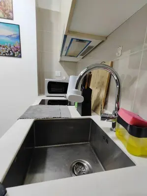 a kitchen counter with a sink and a sink at Vivo Soho Suites by Luvit Stay in Kuala Lumpur