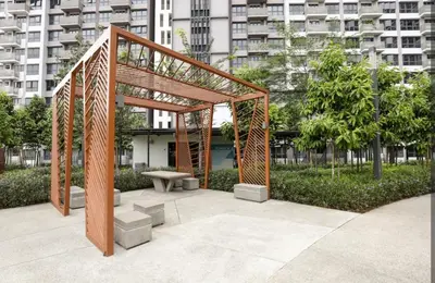 a wooden structure with a bench in a park at M Vertica By Seroja Coliving in Kuala Lumpur