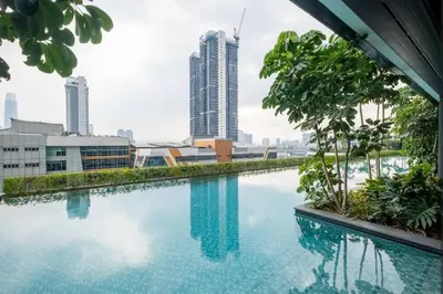 a swimming pool in the middle of a city with tall buildings at Trion KL -2BR, 2-5pax, near KLCC, KL Tower, IKEA, Velocity in Kuala Lumpur