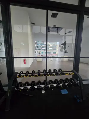 a view of a gym with a row of weights at Reizz Residence Zen Den in Kuala Lumpur
