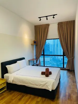 a bedroom with a bed with a teddy bear on it at Reizz Residence Zen Den in Kuala Lumpur