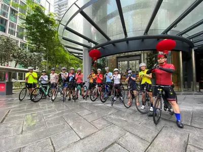 a group of people on bikes with red balloons at Agile Signature Suites KL in Kuala Lumpur