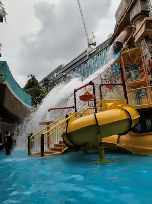 a water slide in the water with a fountain at Agile Signature Suites KL in Kuala Lumpur