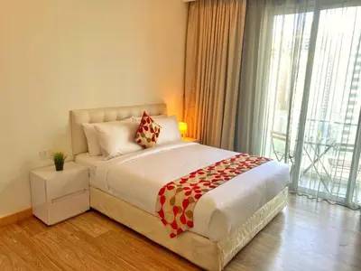 a bedroom with a bed and a large window at One Bukit Ceylon Bukit Bintang in Kuala Lumpur