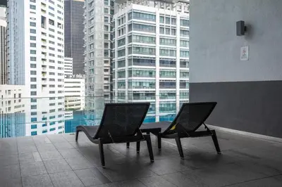 two chairs sitting on top of a building at One Bukit Ceylon Bukit Bintang in Kuala Lumpur