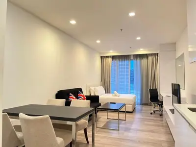 a living room with a couch and a table at One Bukit Ceylon Bukit Bintang in Kuala Lumpur