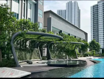 a fountain in the middle of a pool in a city at M Centura Sentul Condominium Two Bedroom in Kuala Lumpur