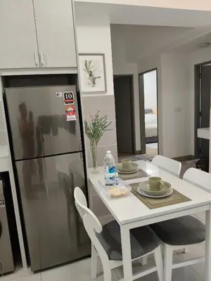 a kitchen and dining room with a white table and chairs at M Centura Sentul Condominium Two Bedroom in Kuala Lumpur