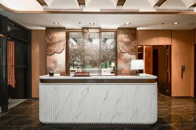 a bar in a hotel lobby with a wall at Atelier KLCC in Kuala Lumpur