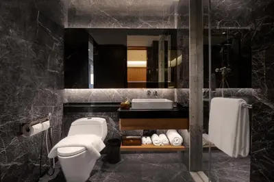 a bathroom with a toilet and a sink and a mirror at Atelier KLCC in Kuala Lumpur