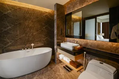 a bathroom with a tub and a sink and a toilet at Atelier KLCC in Kuala Lumpur