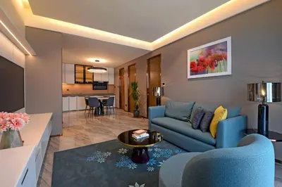 a living room with a blue couch and a table at Atelier KLCC in Kuala Lumpur