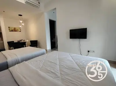 a bedroom with a bed and a tv on the wall at 4Pax Trion Superior 1 Bedroom \u4e2d\u6587\u623f\u4e1c in Kuala Lumpur