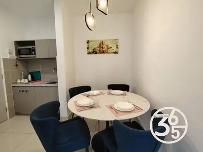 a dining room with a table and blue chairs at 4Pax Trion Superior 1 Bedroom \u4e2d\u6587\u623f\u4e1c in Kuala Lumpur
