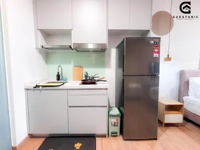 a small kitchen with a stainless steel refrigerator at Riveria City KL Sentral by Guestonic in Kuala Lumpur