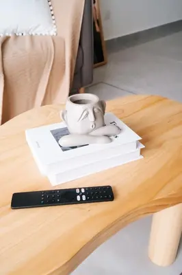a remote control sitting on a table next to a coffee cup at Agile Bukit Bintang in Kuala Lumpur