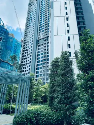 a tall building with trees in front of it at Agile Premier Suites KL in Kuala Lumpur