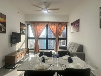 a living room with a table and a couch at Agile Premier Suites KL in Kuala Lumpur