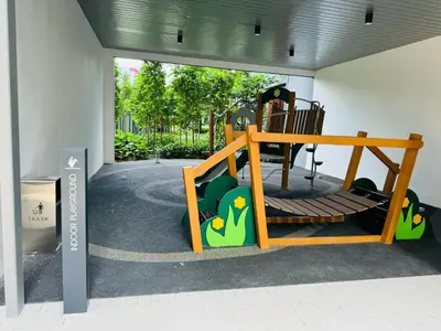 a childrens playground with a swing and a chair at Agile Premier Suites KL in Kuala Lumpur