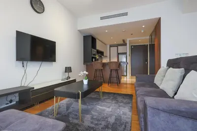 a living room with a couch and a table at Anggun Residences Serviced Suites by GB in Kuala Lumpur