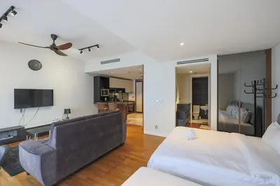 a living room with a bed and a couch at Anggun Residences Serviced Suites by GB in Kuala Lumpur
