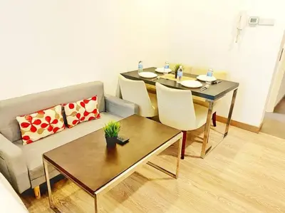 a living room with a table and a couch at One Bukit Ceylon At Pavilion Bukit Bintang in Kuala Lumpur