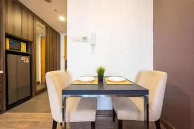 a dining room with a blue table and chairs at One Bukit Ceylon At Pavilion Bukit Bintang in Kuala Lumpur