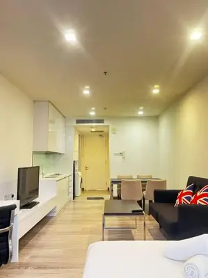 a living room with a couch and a dining room at One Bukit Ceylon At Pavilion Bukit Bintang in Kuala Lumpur