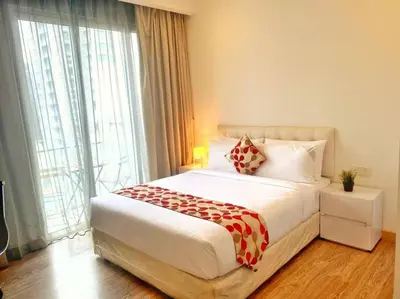 a bedroom with a bed and a large window at One Bukit Ceylon At Pavilion Bukit Bintang in Kuala Lumpur
