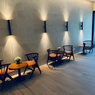 a row of tables and chairs in a room with lights at Platinum 2 KLCC By Natol Chain Of Homestays in Kuala Lumpur