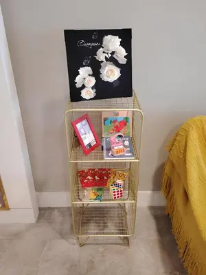 a shelf with toys on it next to a bed at Platinum 2 KLCC By Natol Chain Of Homestays in Kuala Lumpur