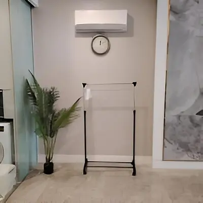 a white room with a clock and a plant at Platinum 2 KLCC By Natol Chain Of Homestays in Kuala Lumpur