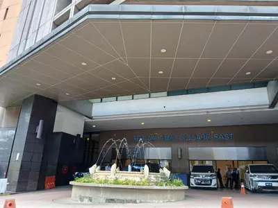 a building with a fountain in front of a car dealership at Jalan imbi Suites At Times Square KL in Kuala Lumpur
