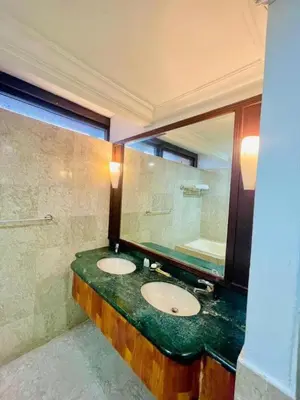 a bathroom with two sinks and a large mirror at Jalan imbi Suites At Times Square KL in Kuala Lumpur