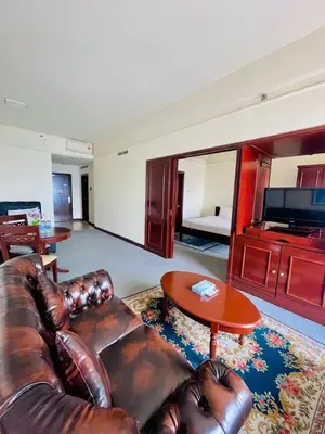 a living room with a leather couch and a table at Jalan imbi Suites At Times Square KL in Kuala Lumpur