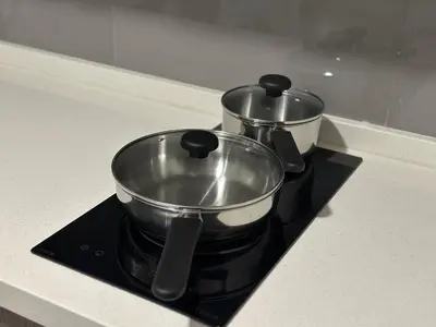 two pots sitting on top of a stove at Agile Bukit Bintang by Romeo Bnb in Kuala Lumpur