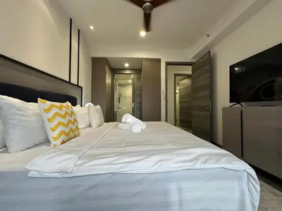 a bedroom with a large white bed with pillows at Agile Bukit Bintang by Romeo Bnb in Kuala Lumpur