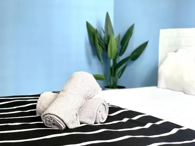 a pile of towels sitting on top of a bed at VR3 Sunway Velocity Spacious Apt\u4e2d\u6587\u623f\u6771 in Kuala Lumpur